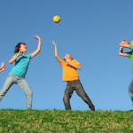 Active kids playing ball at summer camp